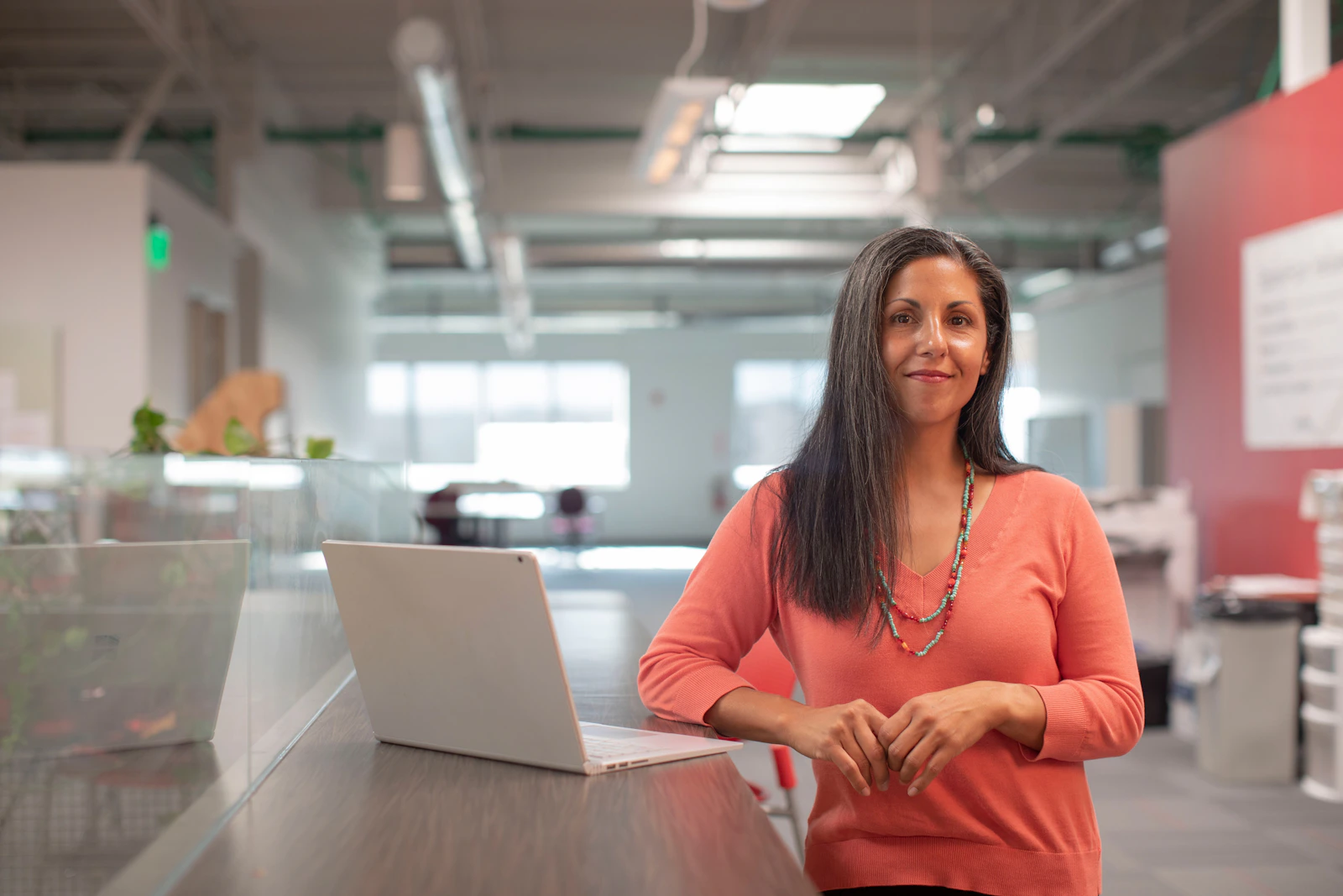 Business owner smiling while working at her laptop